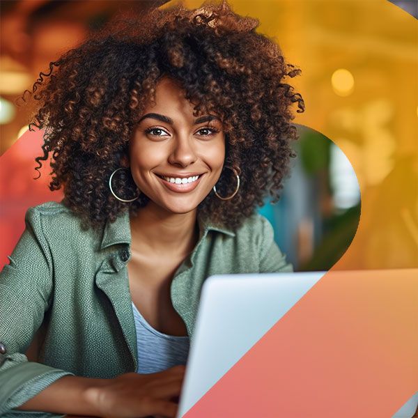 Homepage | Highlights image | Smiling female Mortgage broker at laptop with gradient element wrapping around from front to behind