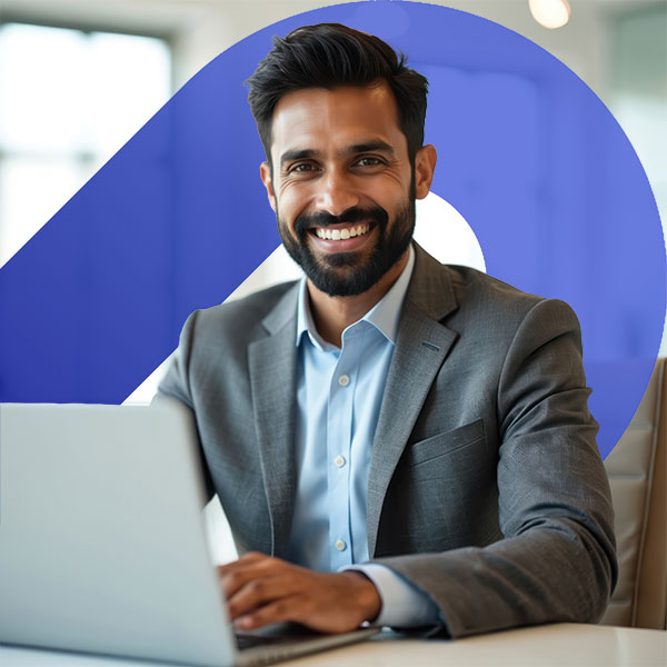 Homepage | Highlights image | Smiling male Mortgage broker at desk withlaptop and Mortgage Brain angled gradient element behind